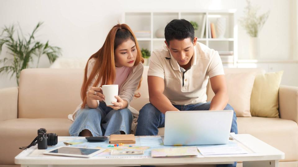 Portrait of couple on computer, fees, America, money, payment, avoid fees, bills, debt