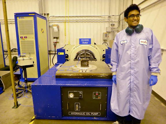 Asha Punnoose beams next to TJ3Sat, a the first CubeSat to be built by high school students and launched into space through NASA's ELaNA program.