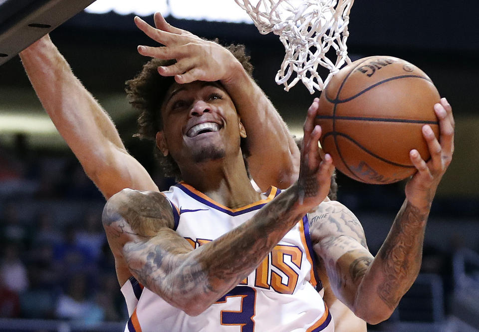 Phoenix Suns forward Kelly Oubre Jr. (3) is fouled by Milwaukee Bucks center Brook Lopez during the second half of an NBA basketball game, Monday, March 4, 2019, in Phoenix. (AP Photo/Matt York)