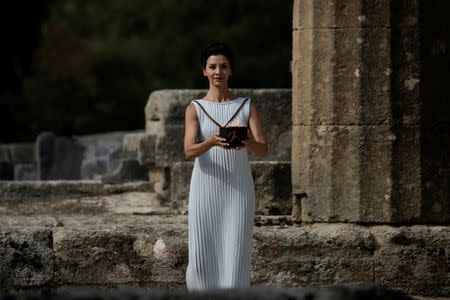 Olympics - Dress Rehearsal - Lighting Ceremony of the Olympic Flame Pyeongchang 2018 - Ancient Olympia, Olympia, Greece - October 23, 2017 Greek actress Katerina Lehou, playing the role of High Priestess, carries the Olympic Flame during the dress rehearsal for the Olympic flame lighting ceremony for the Pyeongchang 2018 Winter Olympic Games at the site of ancient Olympia in Greece REUTERS/Alkis Konstantinidis