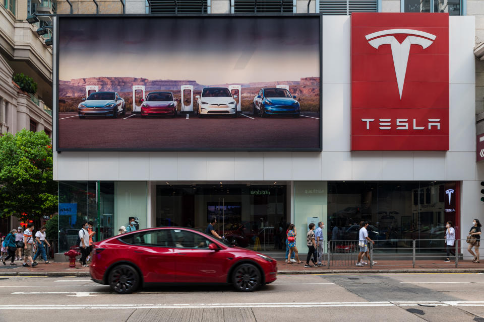 Hong Kong, China, 13 Sept 2022, A red Tesla car passes in front of a Tesla dealership in Wanchai. (Photo by Marc Fernandes/NurPhoto via Getty Images)