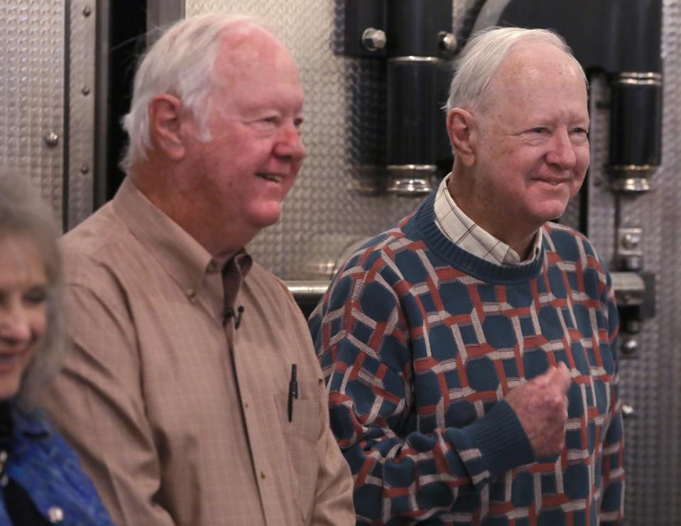 Ron Collins playfully taps himself in the chest as he and his twin brother Don Collins, left, talk about playing the part of Little Pete Bailey at the It's A Wonderful Life Festival in Seneca Falls, NY Friday, Dec. 8, 2023. Each brother jokes that it was actually him in the famous playpen scene that was in the classic movie.