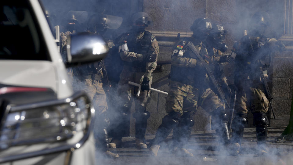 La policía militar se encuentra en medio de gases lacrimógenos que dispararon frente al palacio presidencial en la Plaza Murillo en La Paz, Bolivia, el miércoles 26 de junio de 2024. (AP Foto/Juan Karita)