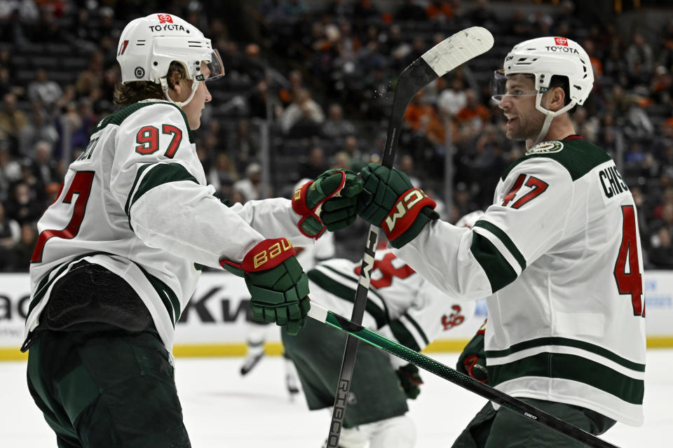 Minnesota Wild left wing Kirill Kaprizov (97) celebrates with defenseman Declan Chisholm (47) after scoring against the Anaheim Ducks during the second period of an NHL hockey game in Anaheim, Calif., Tuesday, March 19, 2024. (AP Photo/Alex Gallardo)