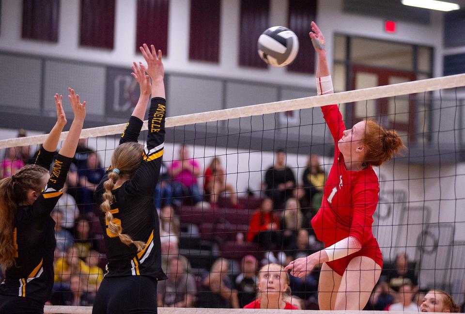 Buckeye Central's Mia McDougal hits the ball over the block of Monroeville's Rachel Fries and Ady Adams.