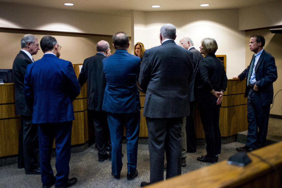 FILE - In this Monday, Jan. 8, 2018 file photo, attorneys meet with Genesee District Judge Jennifer J. Manley as preliminary examination begins in the cases of four defendants, all former or current officials from the Michigan Department of Environmental Quality at Flint District Court in downtown Flint, Mich. Michigan’s attorney general in 2016 promised to investigate the Flint water scandal “without fear or favor” and pledged that state regulators would be locked up for fudging data and misleading the public about lead in the poor city’s pipes. Yet three years later, no one is behind bars. (Jake May/The Flint Journal-MLive.com via AP)