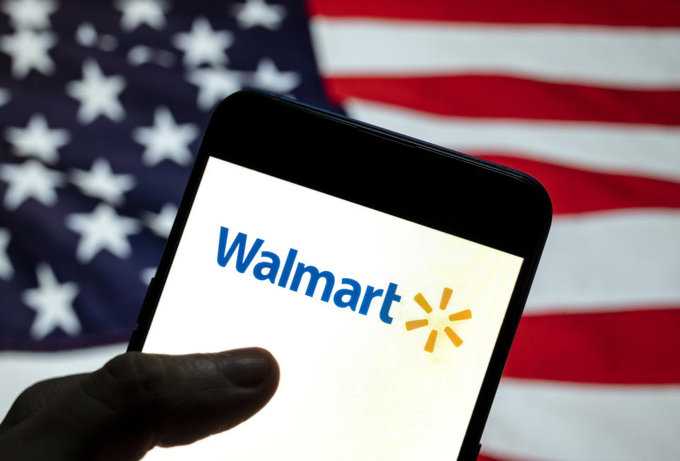 CHINA - 2021/04/02: In this photo illustration the American multinational department stores Walmart logo is seen on an Android mobile device with United States of America (USA), commonly known as the United States (U.S. or US), flag in the background. (Photo Illustration by Budrul Chukrut/SOPA Images/LightRocket via Getty Images)