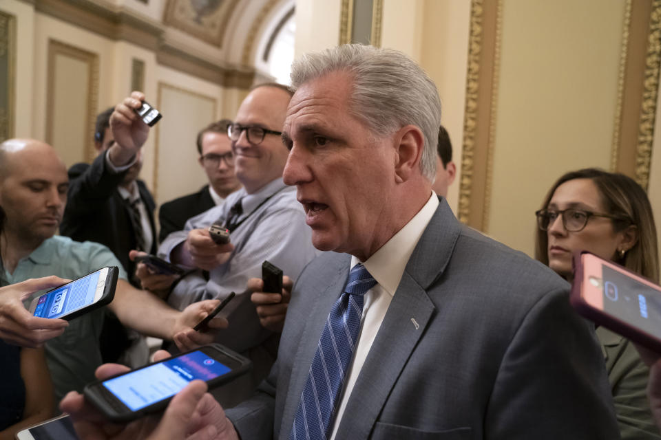 CORRECTS TO R, AS IN REPUBLICAN, INSTEAD OF D, AS IN DEMOCRAT - Speaking to reporters, House Republican Leader Kevin McCarthy, R-Calif., defends recent rhetoric from President Donald Trump as he arrives for votes in the House, at the Capitol in Washington, Thursday, July 18, 2019. McCarthy, a staunch Trump ally, said the president's aversion to Rep. Ilhan Omar, D-Minn., is based on ideology, not race. (AP Photo/J. Scott Applewhite)