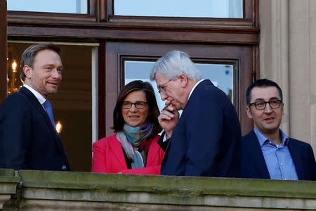 Chairman of the Free Democratic Party (FDP) Christian Lindner, leader of the German Green Party Katrin Goering-Eckardt, federal state premier of Hessen Volker Bouffier and leader of the German Green Party Cem Ozdemir seen on a balcony of German Parliamentary Society offices during the exploratory talks about forming a new coalition government held by CDU/CSU in Berlin, Germany, October 30, 2017. REUTERS/Axel Schmidt