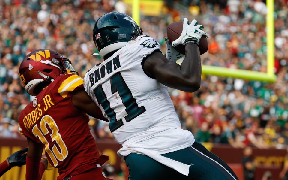 Oct 29, 2023; Landover, Maryland, USA; Philadelphia Eagles wide receiver A.J. Brown (11) catches a touchdown pass as Washington Commanders cornerback <a class="link " href="https://sports.yahoo.com/nfl/players/40033/" data-i13n="sec:content-canvas;subsec:anchor_text;elm:context_link" data-ylk="slk:Emmanuel Forbes;sec:content-canvas;subsec:anchor_text;elm:context_link;itc:0">Emmanuel Forbes</a> (13) defends during the third quarter at FedExField. Mandatory Credit: Geoff Burke-USA TODAY Sports