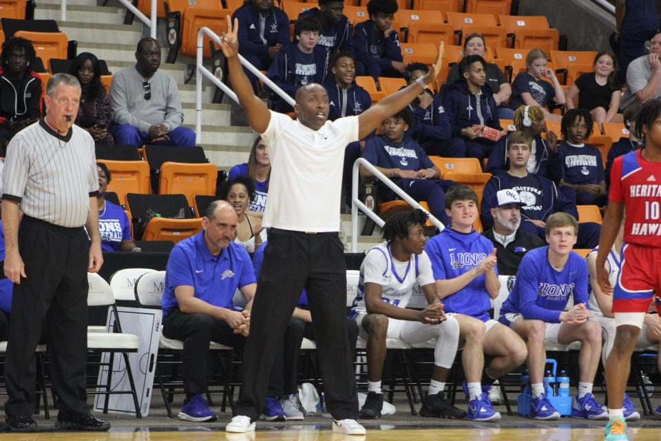 St. Andrew's Coach Mel Abrams gives direction to the Lion defense as St. Andrew's beat Heritage Saturday to win its second straight GIAA state title.