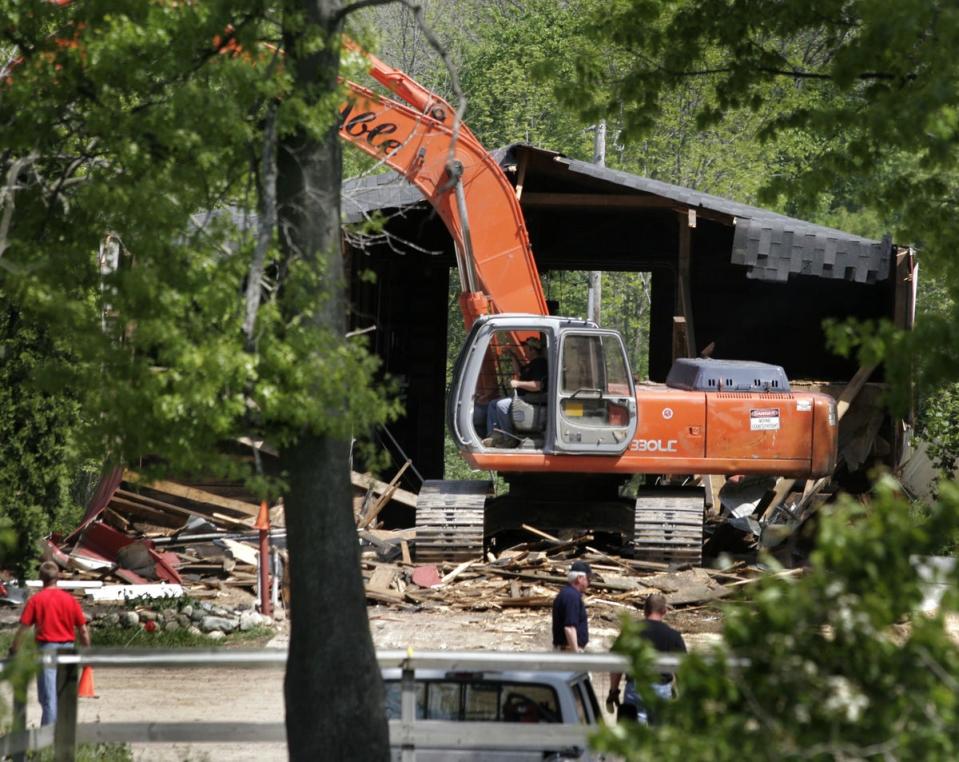 Demolition workers tear down a horse barn for the FBI during the search for Jimmy Hoffa's body at the Hidden Dreams Horse Farm May 24, 2006 in Milford, Michigan (Getty Images)