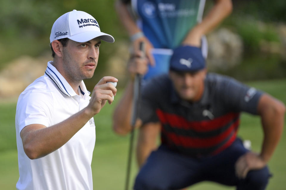 FILE- In this Aug. 29, 2021, file photo, Patrick Cantlay, left, reacts after sinking his putt on the 18th green as Bryson DeChambeau, right, lines up his putt during the final round of the BMW Championship golf tournament at Caves Valley Golf Club in Owings Mills, Md. When DeChambeau arrives at Whistling Straits for the Ryder Cup, the 6-foot-1, 235-pound disrupter with a world-leading driving average of 323.7 yards, will bring with him an epic amount of baggage. He’s had encounters that range from awkward moments to full-fledged fights with everyone from his equipment reps, to photographers, to his former caddie, to FedEx Cup champion Patrick Cantlay, another long-time foe who, for one week, will be his teammate. (AP Photo/Nick Wass, File)