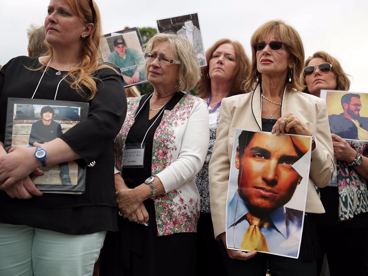 Family members hold the pictures of their love ones who killed by opioid epidemic.