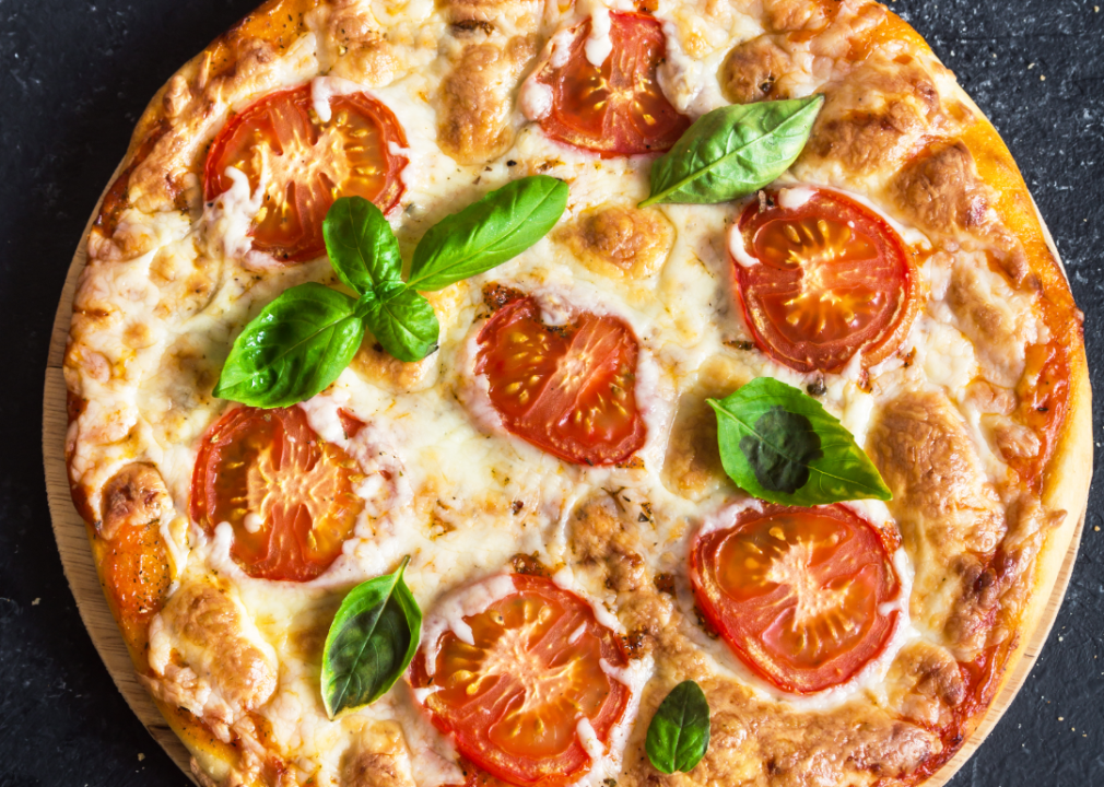 Slices of tomato on pizza.