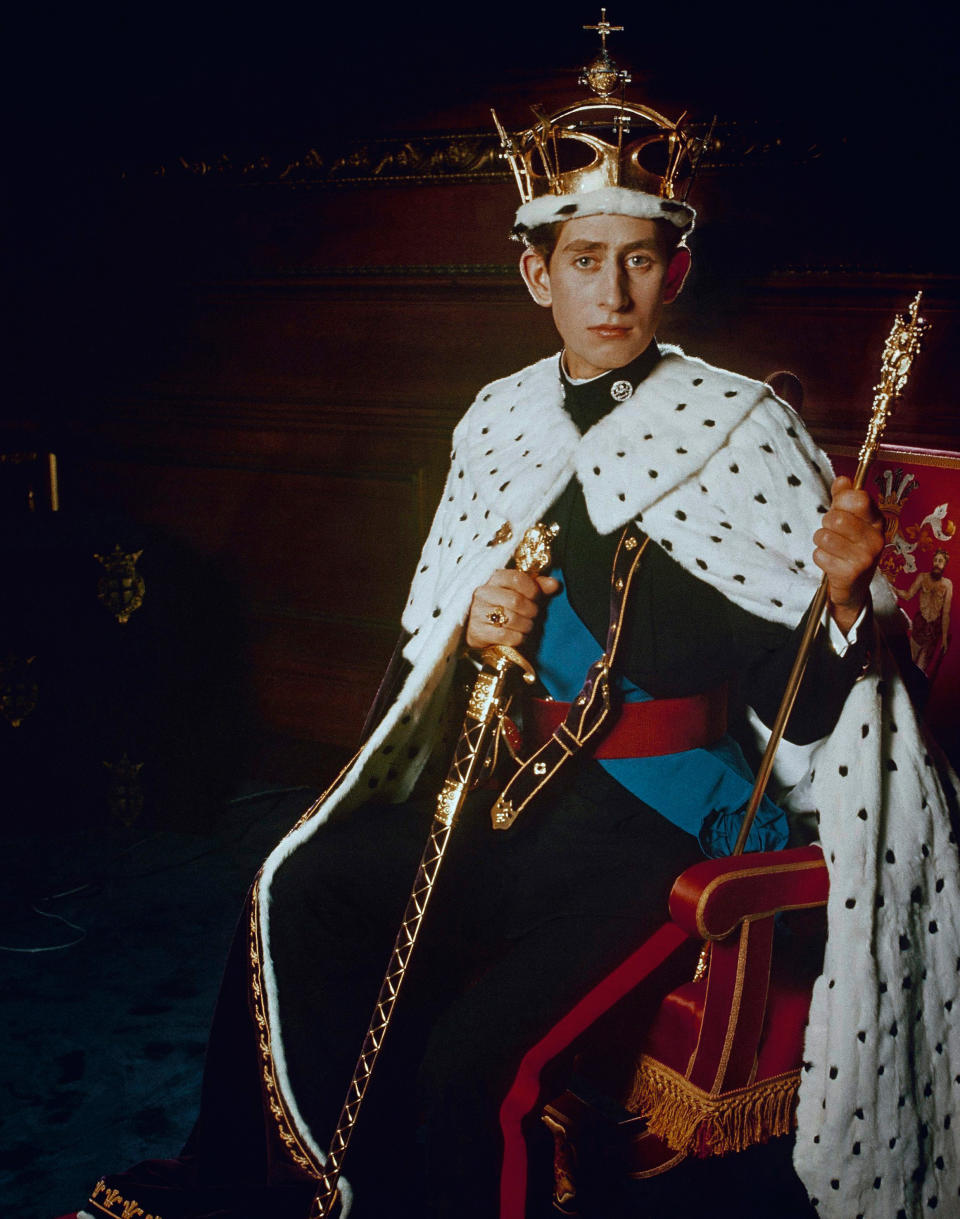 FILE - In this 1969 file photo, Britain's Prince Charles, the Prince Of Wales poses for a photo dressed in his investiture regalia. Prince Charles is readying the paperwork to claim his pension when he turns 65 on Thursday, Nov. 14, 2013, but he still hasn't started the job he was born to do. (AP Photo/Pool, File)