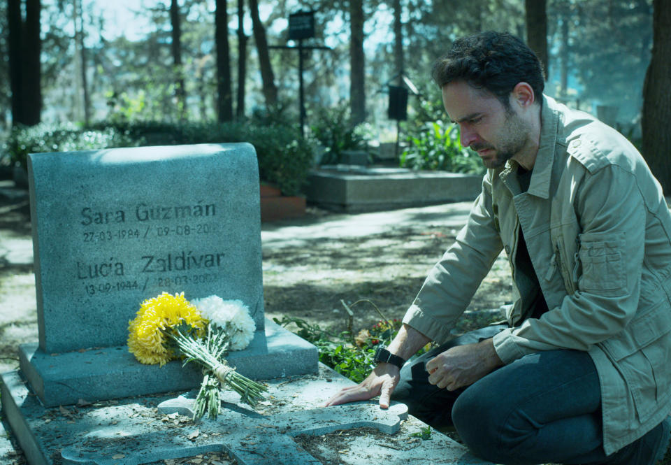 Alex standing over Sara's grave