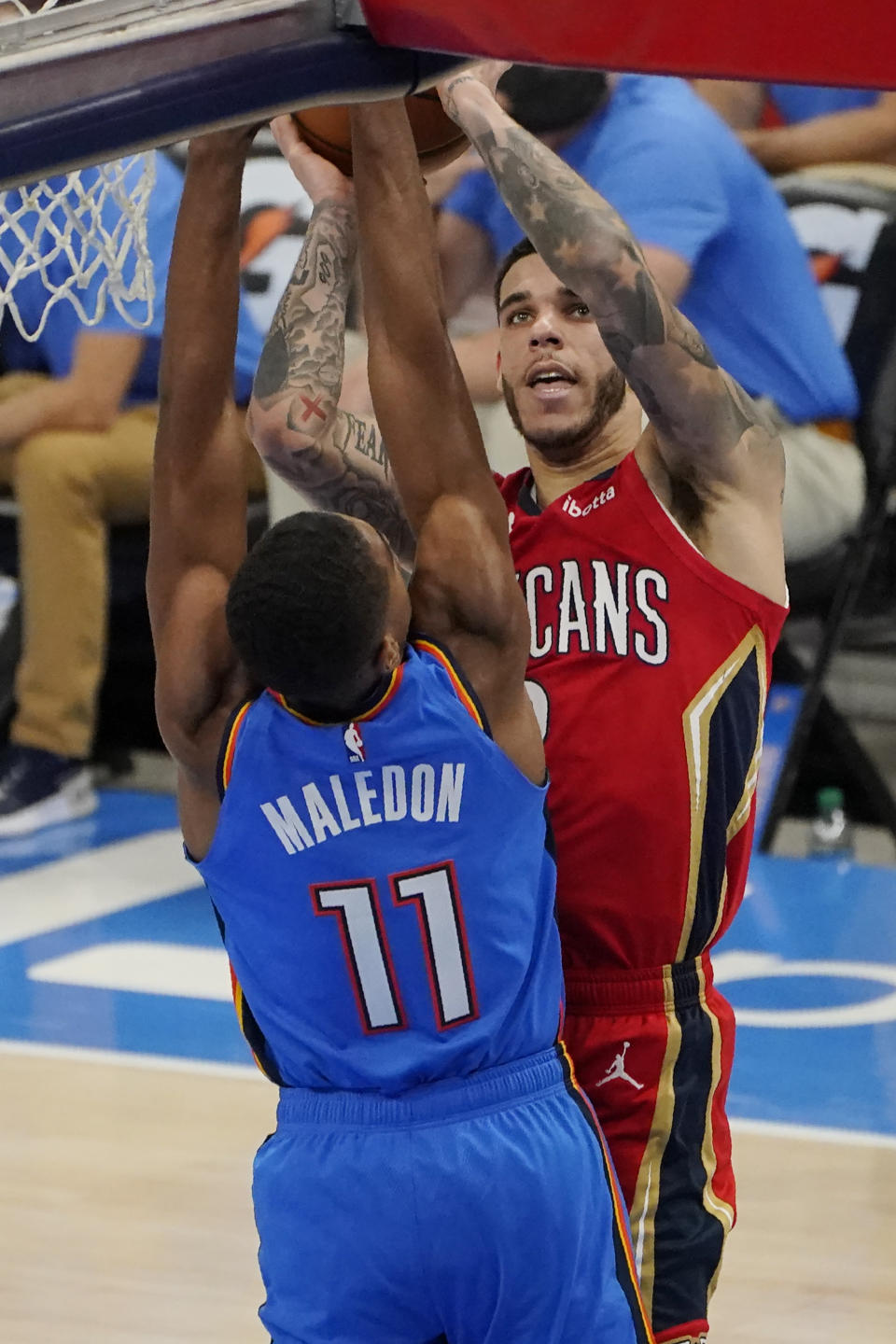 New Orleans Pelicans guard Lonzo Ball, right, shoots over Oklahoma City Thunder guard Theo Maledon (11) in the second half of an NBA basketball game Thursday, Dec. 31, 2020, in Oklahoma City. (AP Photo/Sue Ogrocki)