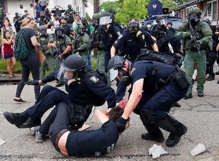 A demonstrator is detained by police during protests in Baton Rouge, Louisiana, U.S., July 10, 2016. REUTERS/Shannon Stapleton