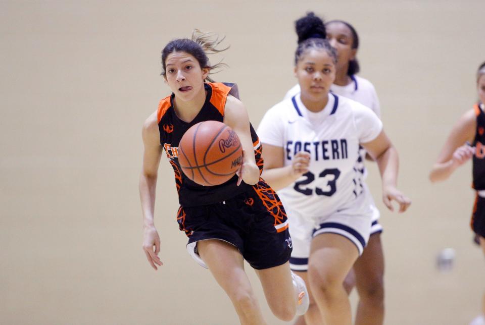 Charlotte's Jaelyn Baker pushes the ball up court on a fast break ahead of Lansing Eastern's Trayshawn Holbrook, Tuesday, Nov. 30, 2021, in Lansing, Mich. Charlotte won 53-13.