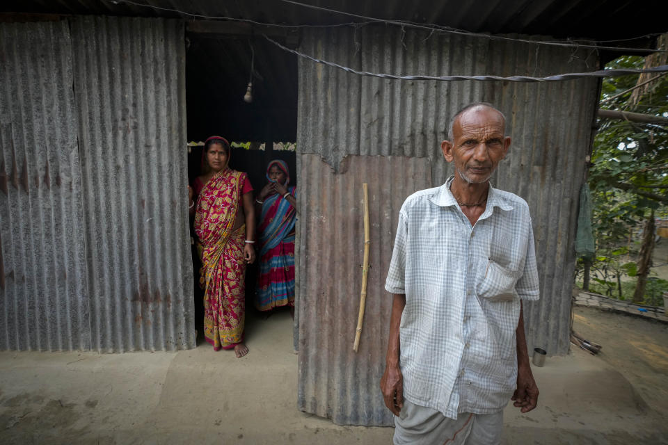 Hariprada Biswas, 66, who has not been able to prove his Indian citizenship, stands outside his house in Murkata village, north eastern Assam state, India, April 15, 2023. Millions of people like Biswas, whose citizenship status is unclear, were born in India to parents who immigrated many decades ago. Nearly 2 million people, or over 5% of Assam's population, could be stripped of their citizenship unless they have documents dating back to 1971 that show their ancestors entered the country legally from neighboring Bangladesh.(AP Photo/Anupam Nath)