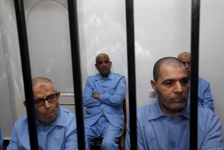 Former intelligence chief of Gaddafi's regime Abdullah al-Senussisi (C) and other Gaddafi regime officials sit behind bars during a verdict hearing at a courtroom in Tripoli, Libya July 28, 2015. REUTERS/Ismail Zitouny