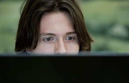 Raffaele Sollecito works at his computer before a news conference in Rome July 1, 2014. REUTERS/Remo Casilli