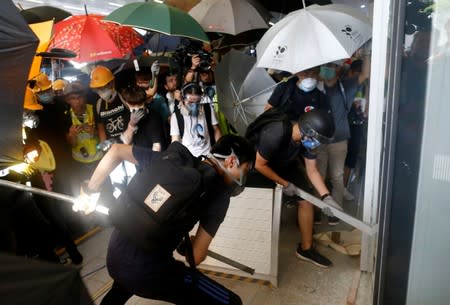 Protesters break into the Legislative Council building during the anniversary of Hong Kong's handover to China in Hong Kong