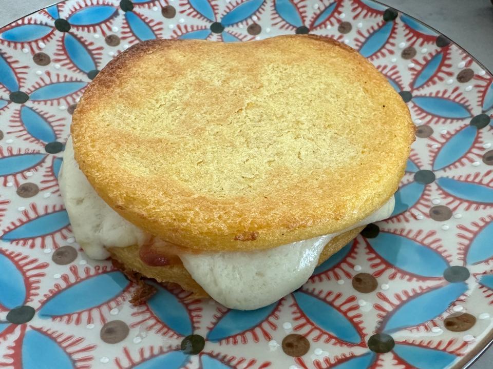 cooked arepa on a colorful plate