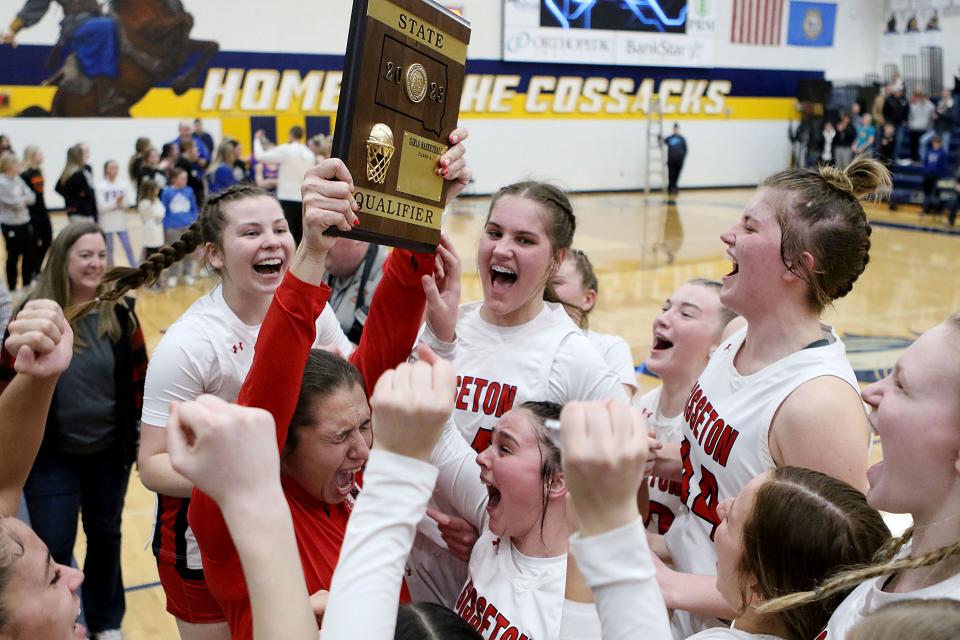 Sisseton head girls basketball coach Sara Lincoln holds up the state qualifier trophy after the Redmen defeated Parkston 59-46 in SoDak 16 Class A matchup on Thursday, March 2, 2023 at Sioux Valley High School in Volga.