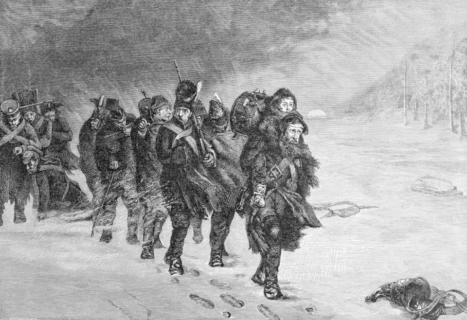 An etching of hunched-over men walking in a bitter snowstorm. The man in the front is carrying a young boy with a drum on his back on his shoulders.