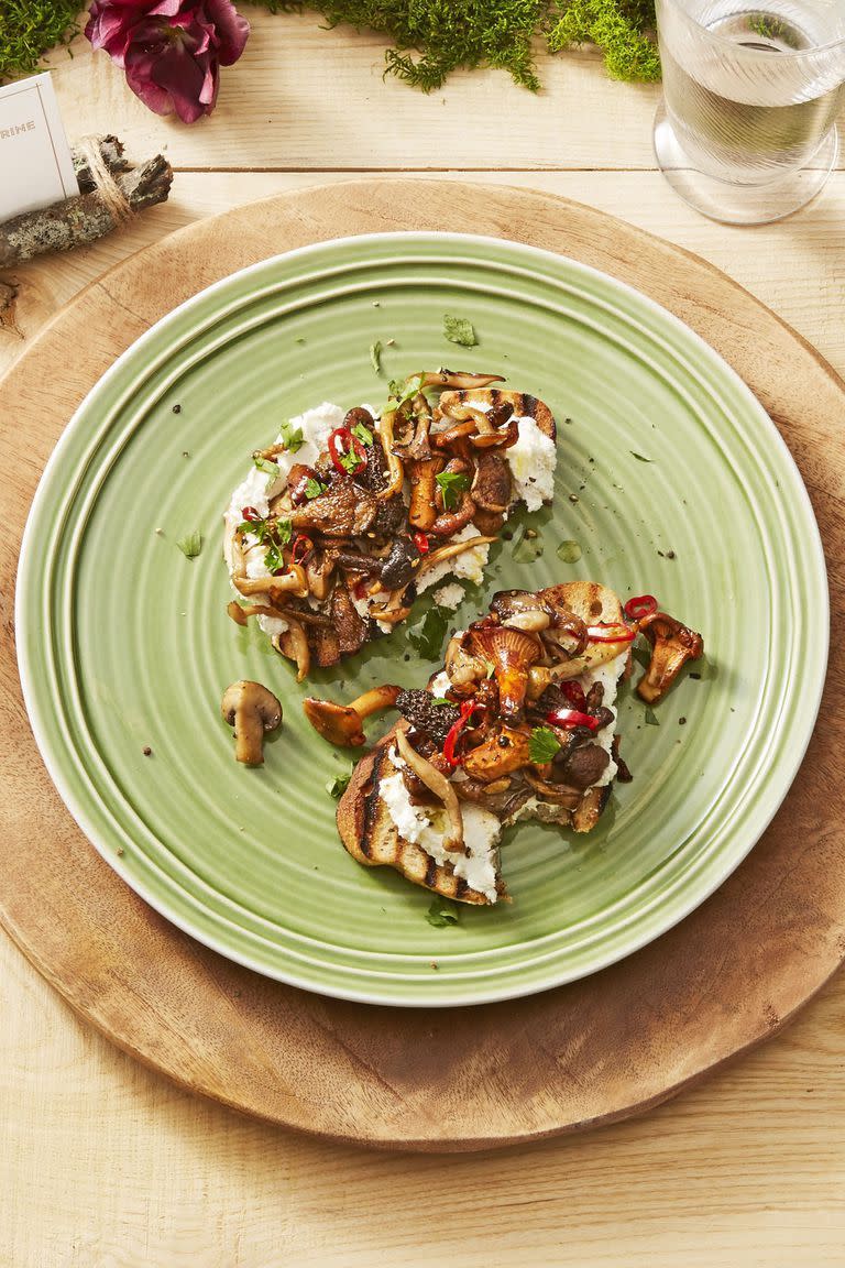 wild mushroom toasts on a green plate
