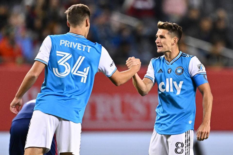 Charlotte FC midfielder Andrew Privett (34) and midfielder Ashley Westwood (8) celebrate after a victory over the Chicago Fire FC at Soldier Field.