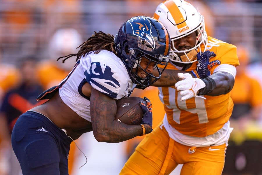 UTSA running back Robert Henry, left, stiff-arms Tennessee linebacker Elijah Herring (44) during the first half of an NCAA college football game Saturday, Sept. 23, 2023, in Knoxville, Tenn. (AP Photo/Wade Payne)