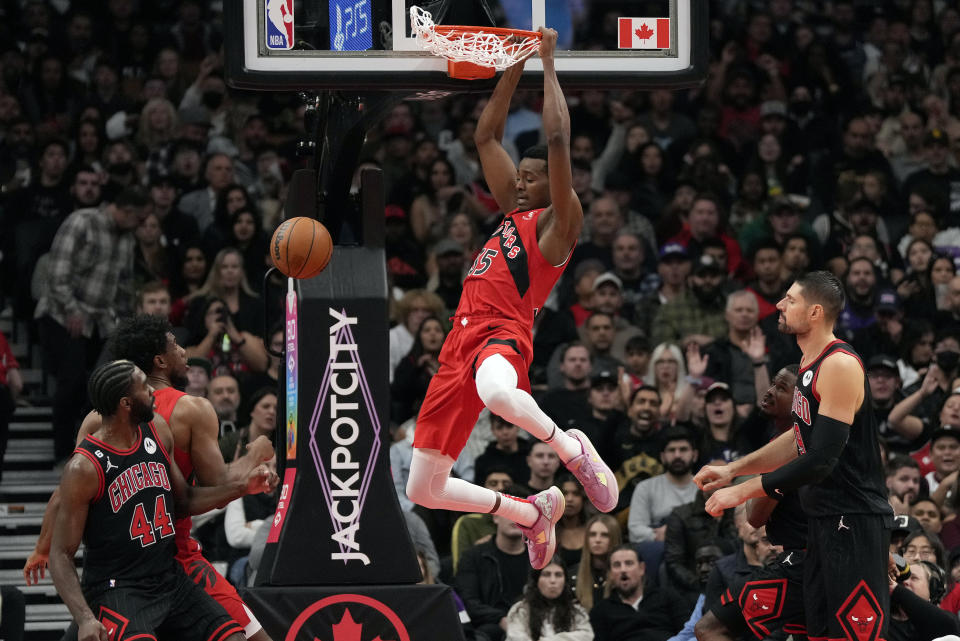 Toronto Raptors forward Christian Koloko (35) dunks against the Chicago Bulls during first-half NBA basketball game action in Toronto, Sunday, Nov. 6, 2022. (Frank Gunn/The Canadian Press via AP)