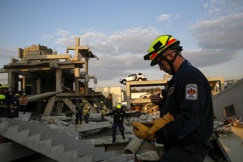 Rescue specialists for USA-1 work at the scene of a mock disaster area during a training exercise at the Guardian Center in Perry, Georgia, March 25, 2014. (REUTERS/Shannon Stapleton)