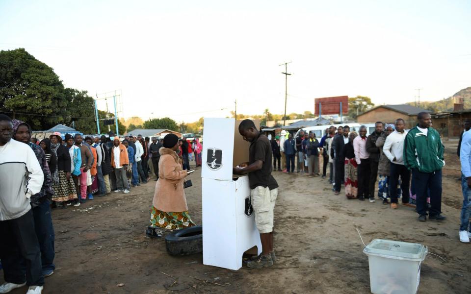 People line up to cast their votes in Blantyre, Malawi - AP