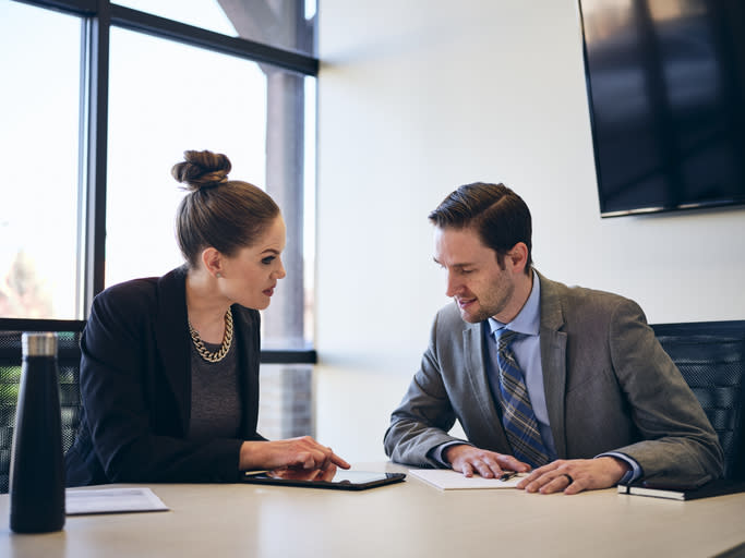 Financial advisors discussing a marketing strategy to attract annuity leads.