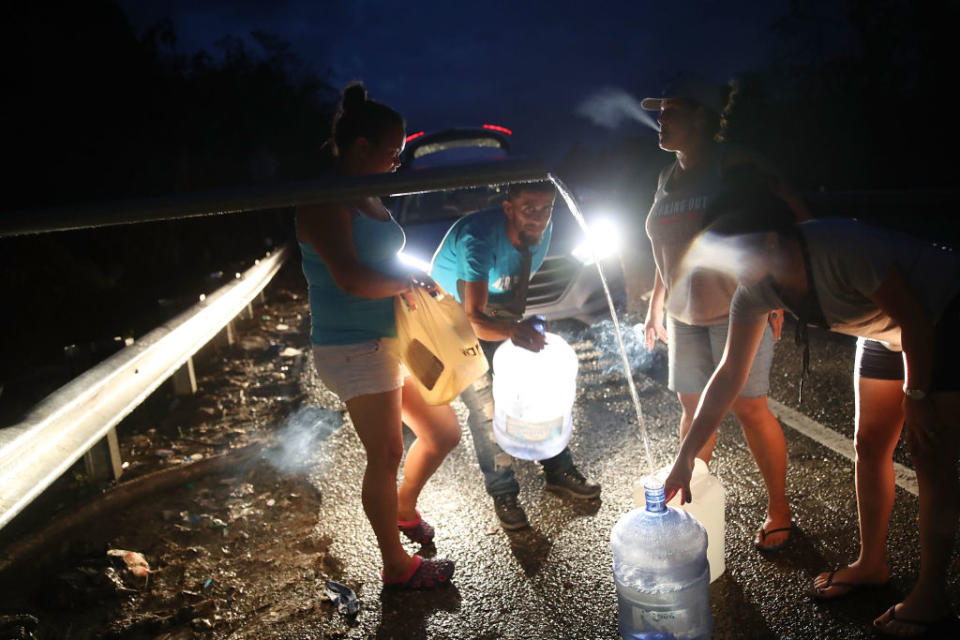 UTUADO, PUERTO RICO - OCTOBER 06: People collect spring water in containers from a pipe along side a highway since they have no running water in their home after Hurricane Maria passed through on October 6, 2017 in Utuado, Puerto Rico. Puerto Rico experienced widespread damage including most of the electrical, gas and water grid as well as agriculture after Hurricane Maria, a category 4 hurricane, passed through. (Photo by Joe Raedle/Getty Images)