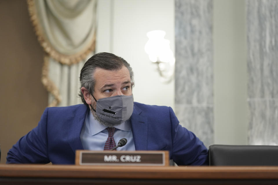 Sen. Ted Cruz, R-Texas, wears a face mask as he arrives for a confirmation hearing for Transportation Secretary nominee Pete Buttigieg before the Senate Commerce, Science and Transportation Committee on Capitol Hill, Thursday, Jan. 21, 2021, in Washington.. (Stefani Reynolds/Pool via AP)