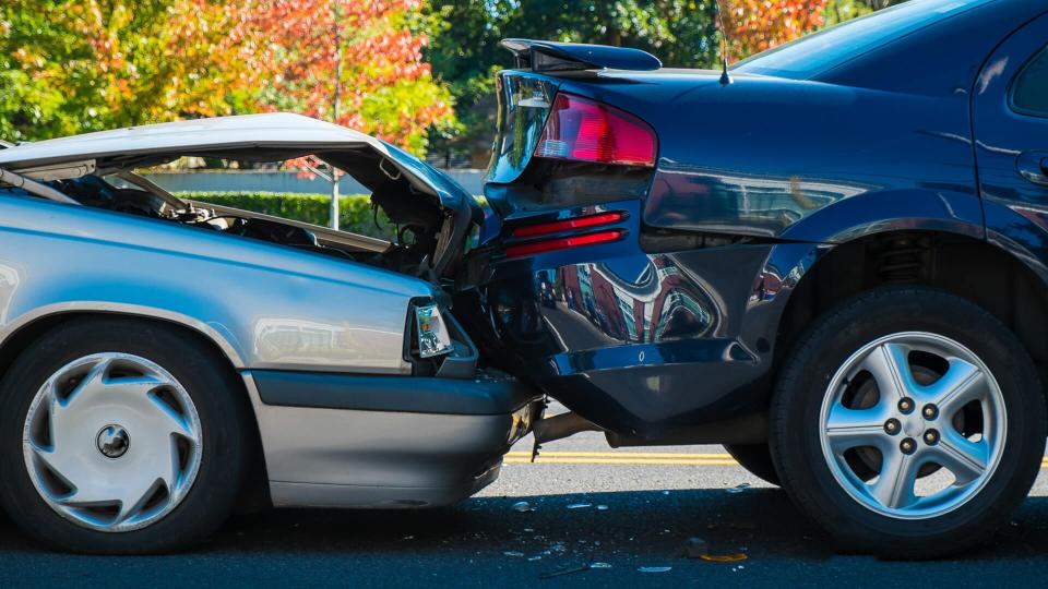 Auto accident involving two cars on a city street.