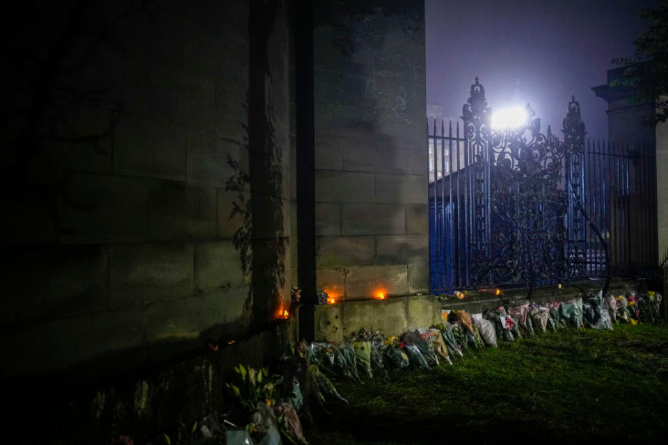 Floral tributes following the death of Queen Elizabeth II are placed outside the gates of Holyrood Palace on Sept. 8, 2022 in Edinburgh, United Kingdom.<span class="copyright">Christopher Furlong/Getty Images</span>