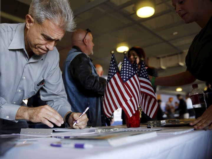 A job seeker fills out papers at a military job fair in San Francisco, California, August 25, 2015. The employment workshop, held by the U.S. Chamber of Commerce Foundation, attracted hundreds of veterans and 115 companies. REUTERS/Robert Galbraith - RTX1PN8R