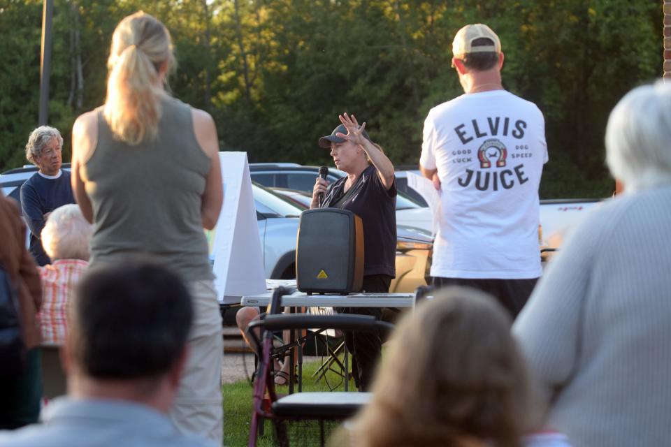 Kim Fary speaks to a crowd of about 60 Hayes Township residents about the township master plan and proposed rezoning ordinances on Tuesday, Sept. 20 outside the township hall at 9195 Major Douglas Sloan Road after the township canceled the September planning commission meeting.