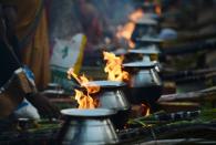 <p>Indian Hindu devotees prepare a traditional sweet dish on open fires during an event to mark Pongal in Mumbai on January 15, 2016. Pongal, which coincides with the Hindu festival Makara Sankranthi, is a thanksgiving and harvest celebrated throughout India and specifically by those from the Indian state of Tamil Nadu. </p>