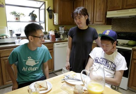Un Bang (C) spends time with her sons, Shane Bang (L), 21, and Simon Bang (R), 18, at their home in Federal Way, Washington August 8, 2015. REUTERS/Jason Redmond