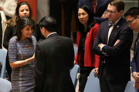 U.S. Ambassador to the United Nations Nikki Haley (L) speaks with Chinese Deputy Ambassador to the United Nations Wu Haitao (R) ahead of the United Nations Security Council session on imposing new sanctions on North Korea, in New York, U.S., December 22, 2017. REUTERS/Amr Alfiky