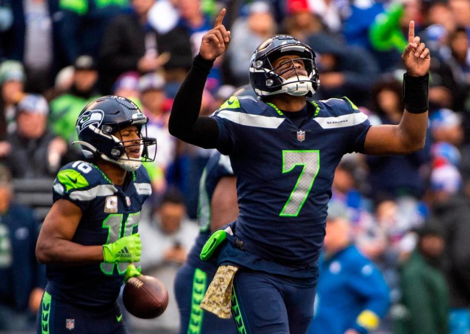 Seattle Seahawks quarterback Geno Smith (7) points to the sky as he jogs off the field after passing the ball to Seattle Seahawks wide receiver Tyler Lockett (16) and scoring a touchdown in the fourth quarter of an NFL game at Lumen Field in Seattle, Wash. on Oct. 30, 2022. The Seahawks defeated the Giants 27-13.