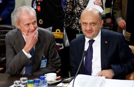 Spanish Defence Minister Pedro Morenes and Turkish counterpart Fikri Isik (R) attend a NATO defence ministers meeting at the Alliance headquarters in Brussels, Belgium October 27, 2016. REUTERS/Francois Lenoir