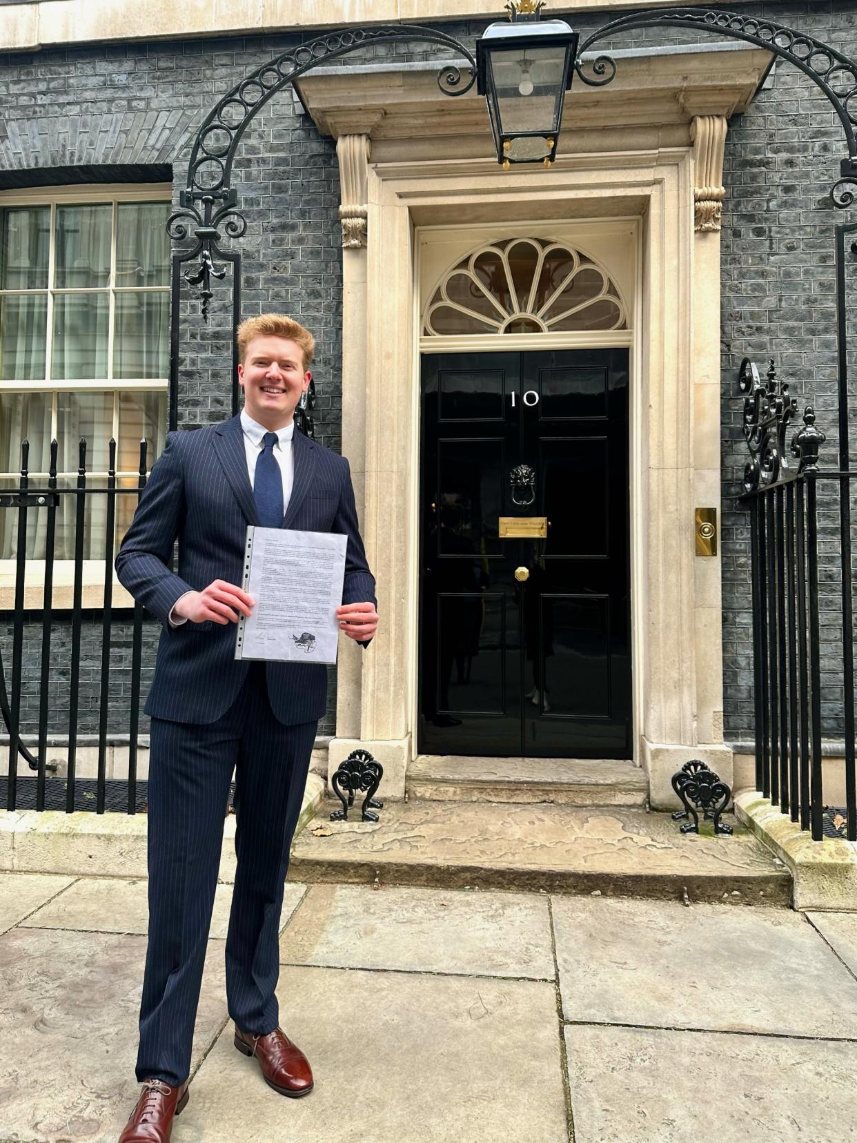 Man posing with letter